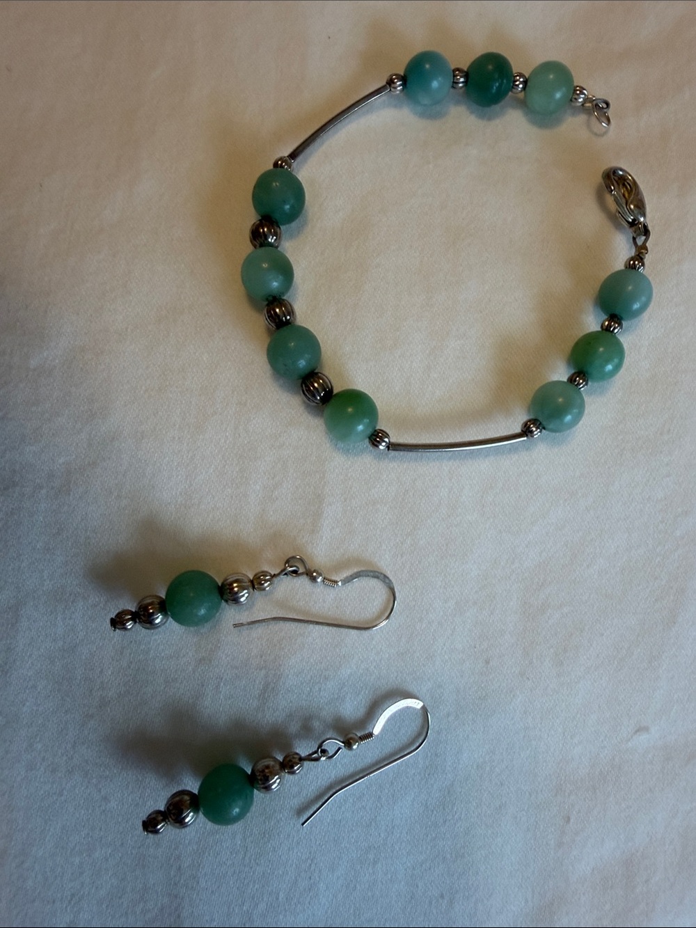 Handmade green stone and silver tube bracelet with matching earrings.